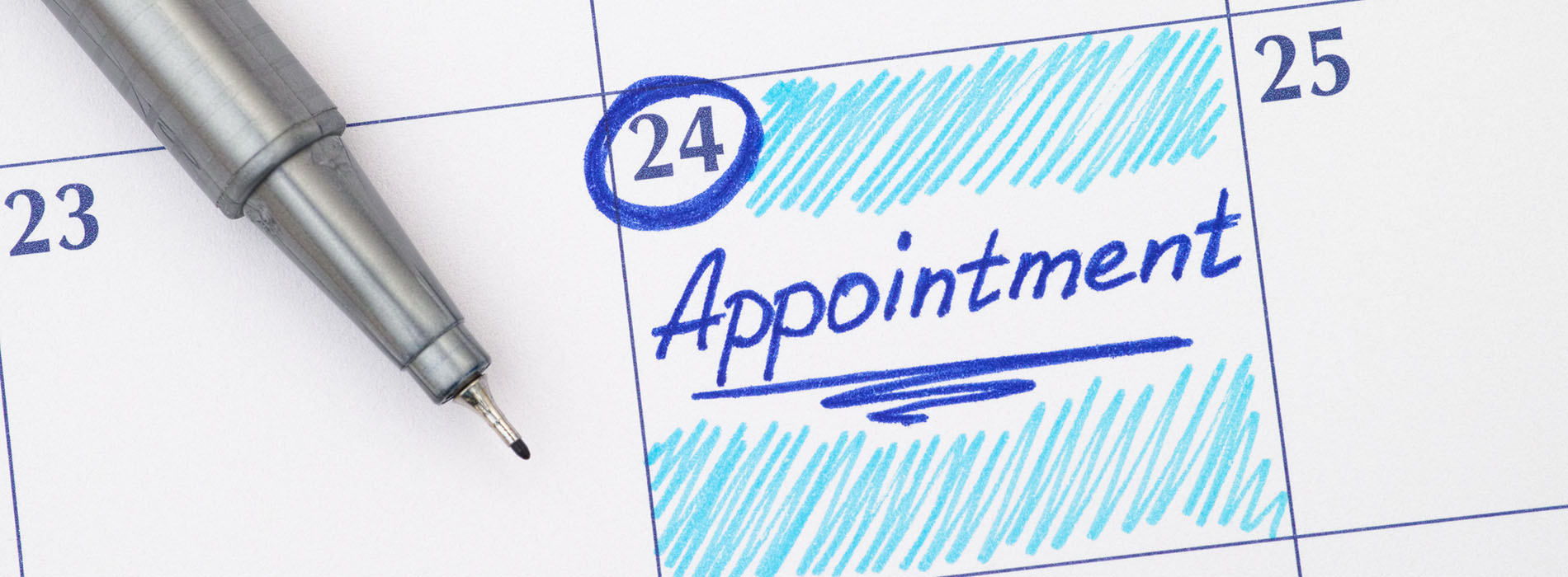 The image shows a close-up view of a pen resting on a calendar page with the word  appointment  written on it, indicating a scheduled event.