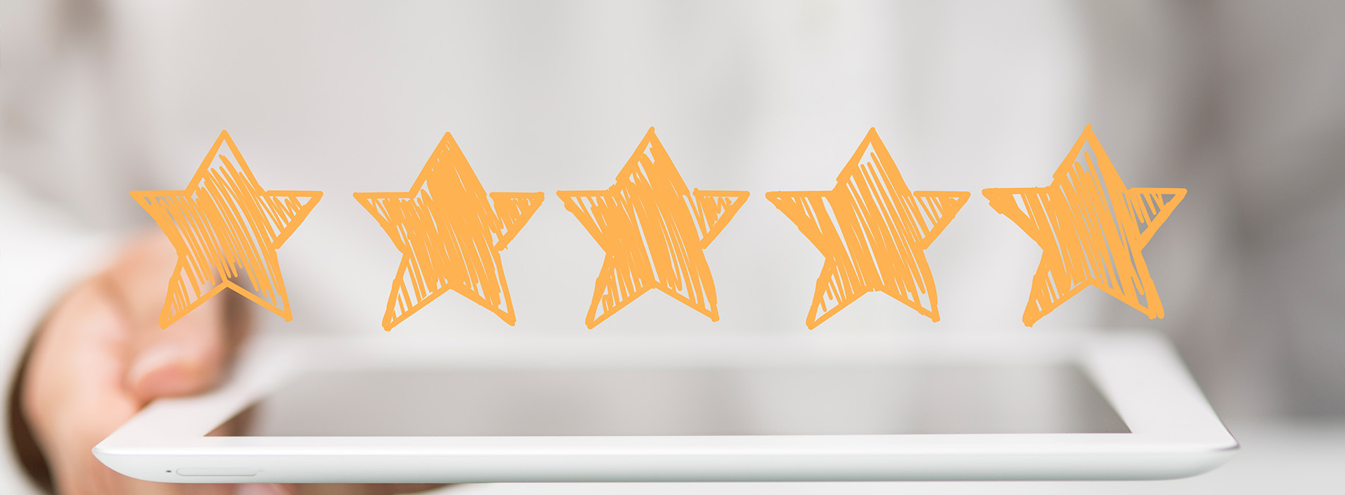 The image shows a hand holding a tablet with an overlaid graphic of a star rating, suggesting a focus on customer satisfaction or review ratings.